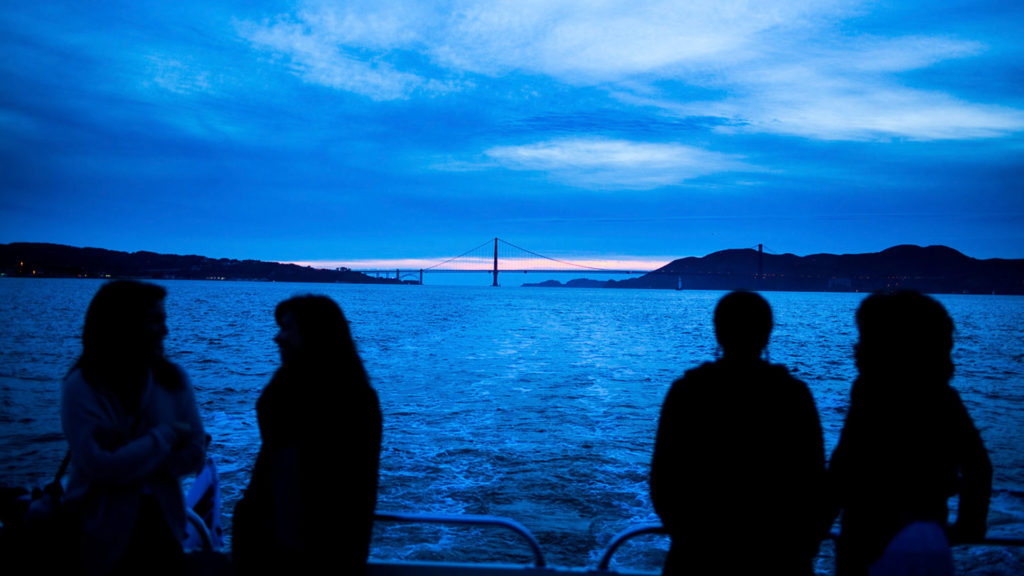 People on the water at dusk