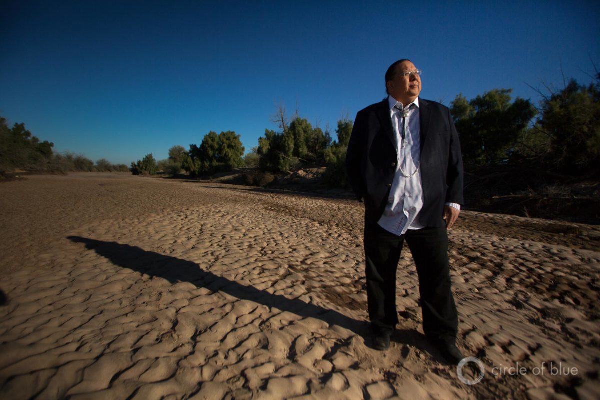 Governor Stephen Roe Lewis, leader of the Gila River Indian Community, stands in the dry bed of the Gila River, outside of Sacaton, Arizona.