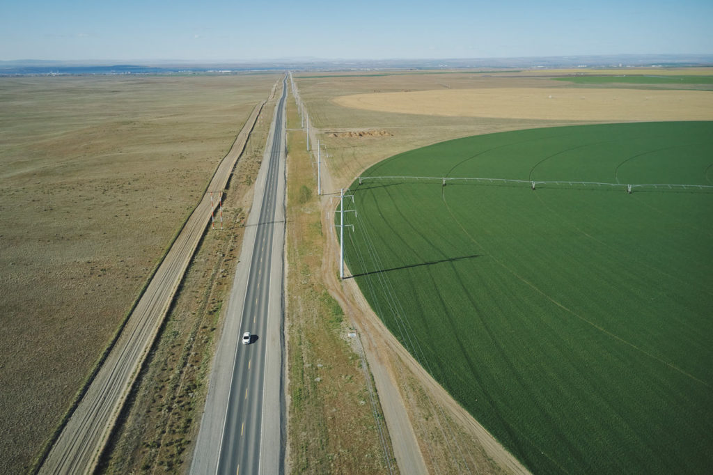 Aerial view of Bombing Range Road diving a disused US Navy bombing range and large areas of irrigated green land.