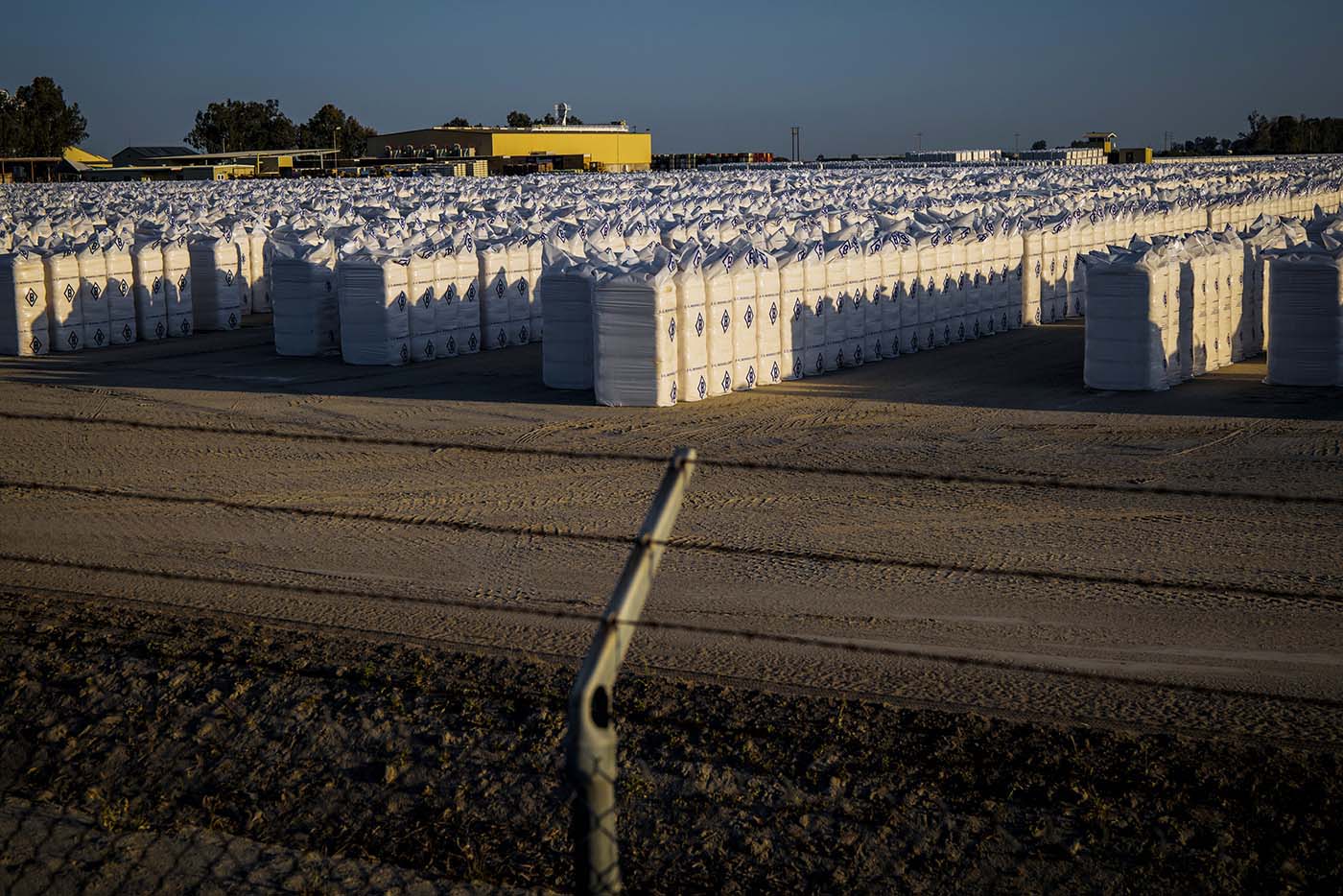 Bales of ginned cotton sit at J. G. Boswell Company’s bale yard in Corcoran, California.