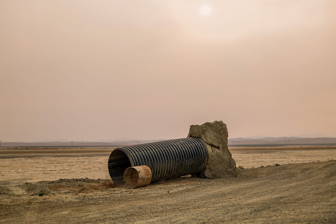 A pipe remnant from an old water movement infrastructure system sits abandoned next to the Blakeley Canal in Kings County, California