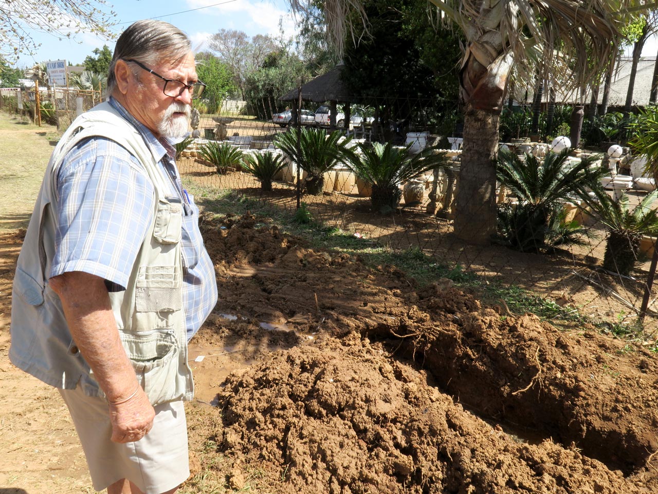 Emalahleni resident Hennie Beuke inspects a burst water pipe on the verge outside his property