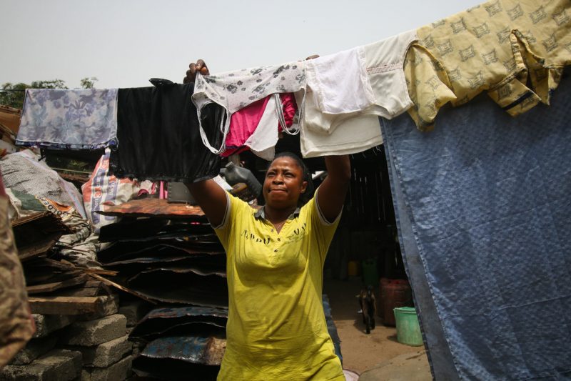 A woman hangs laundry outside